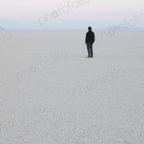 Man standing in vast, desert landscape