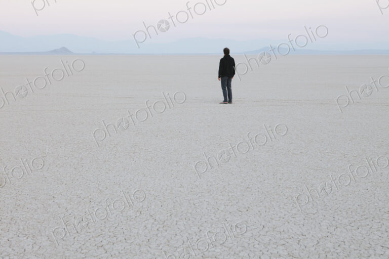 Man standing in vast, desert landscape