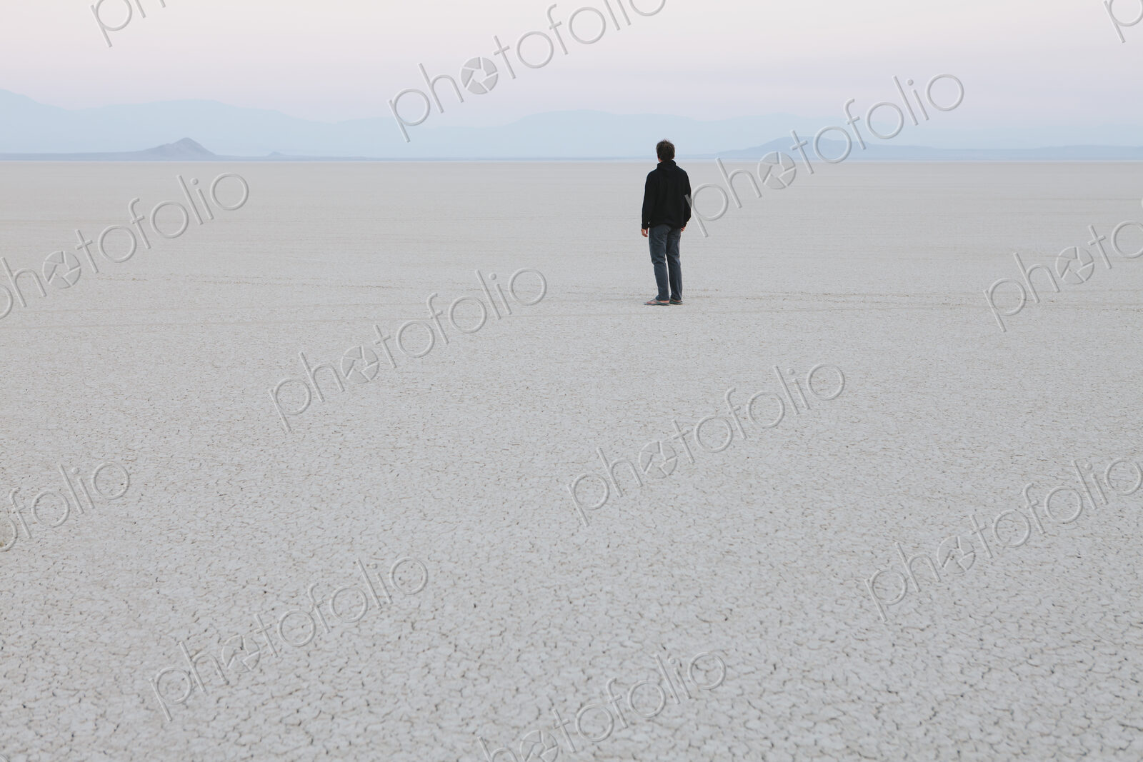 Man standing in vast, desert landscape