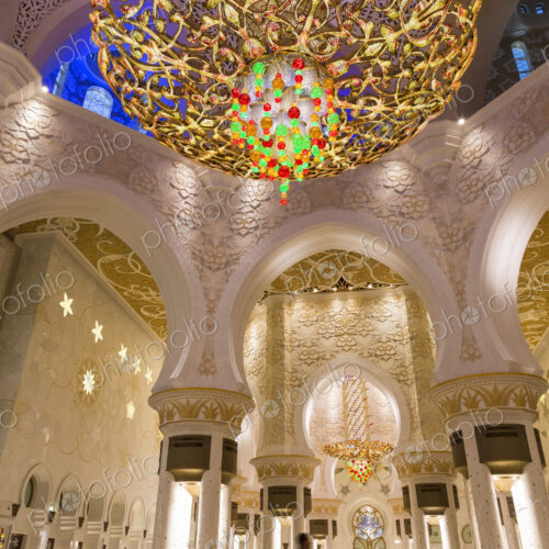 Man standing underneath white and golden dome of Sheikh Zayed Mosque Man standing underneath white and golden dome of Sheikh Zayed Mosque