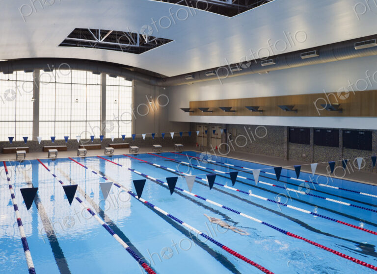 Man swimming in a indoor swimming pool.