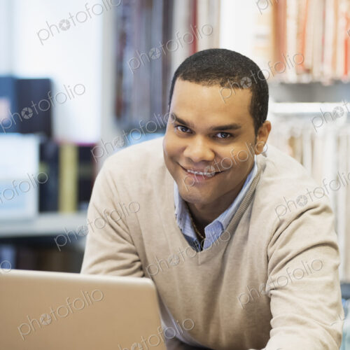 Man working in design shop with laptop