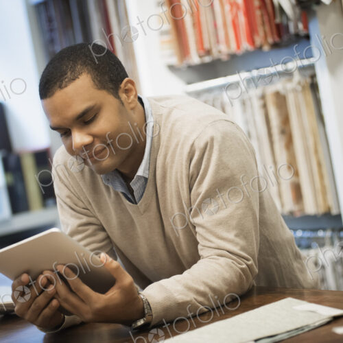 Man working in design shop with tablet