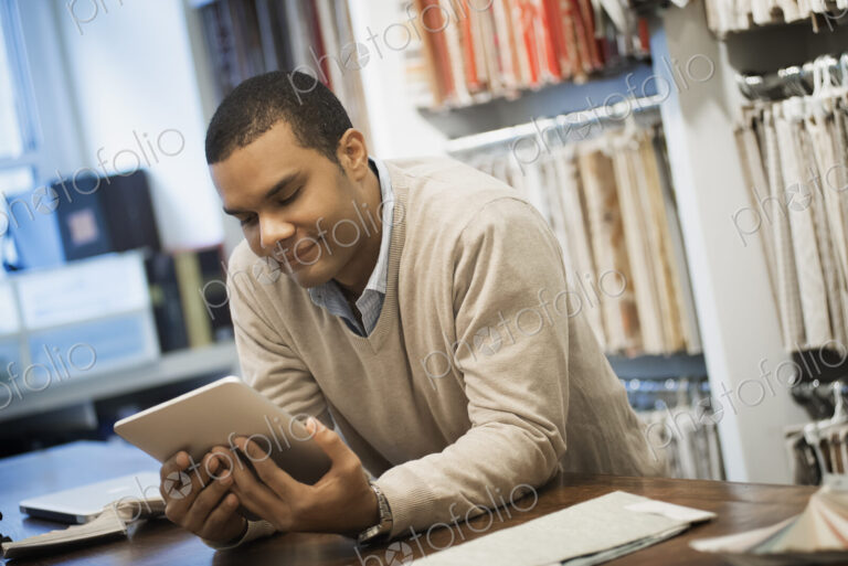 Man working in design shop with tablet