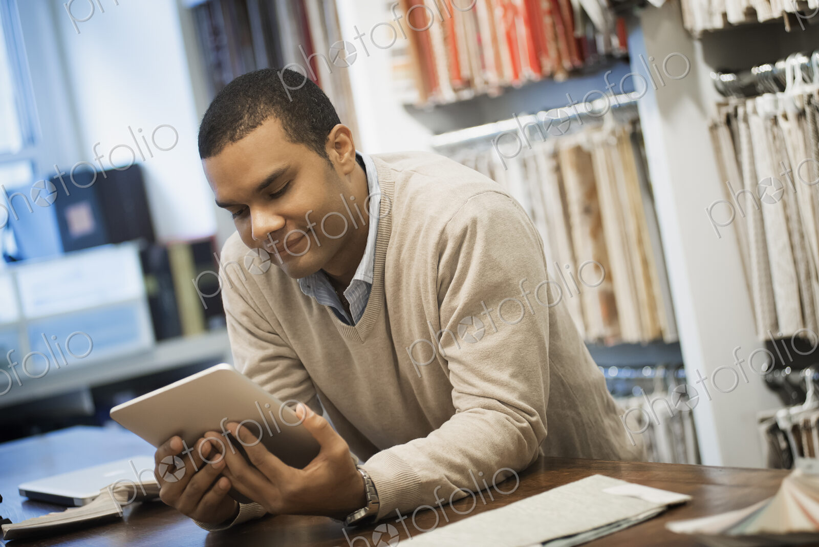 Man working in design shop with tablet