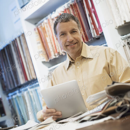 Man working in design shop with tablet