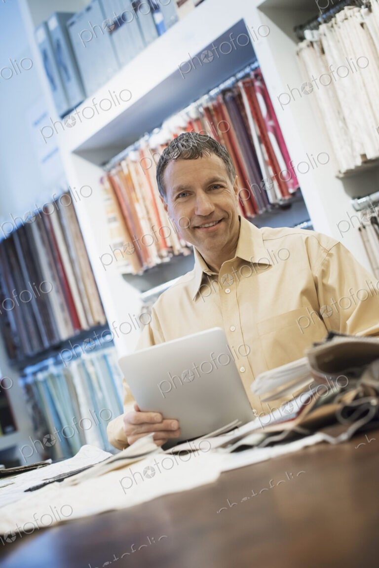 Man working in design shop with tablet