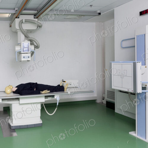 Mannequin lying on a table under an x ray machine in a training college Mannequin lying on a table under an x ray machine in a training college