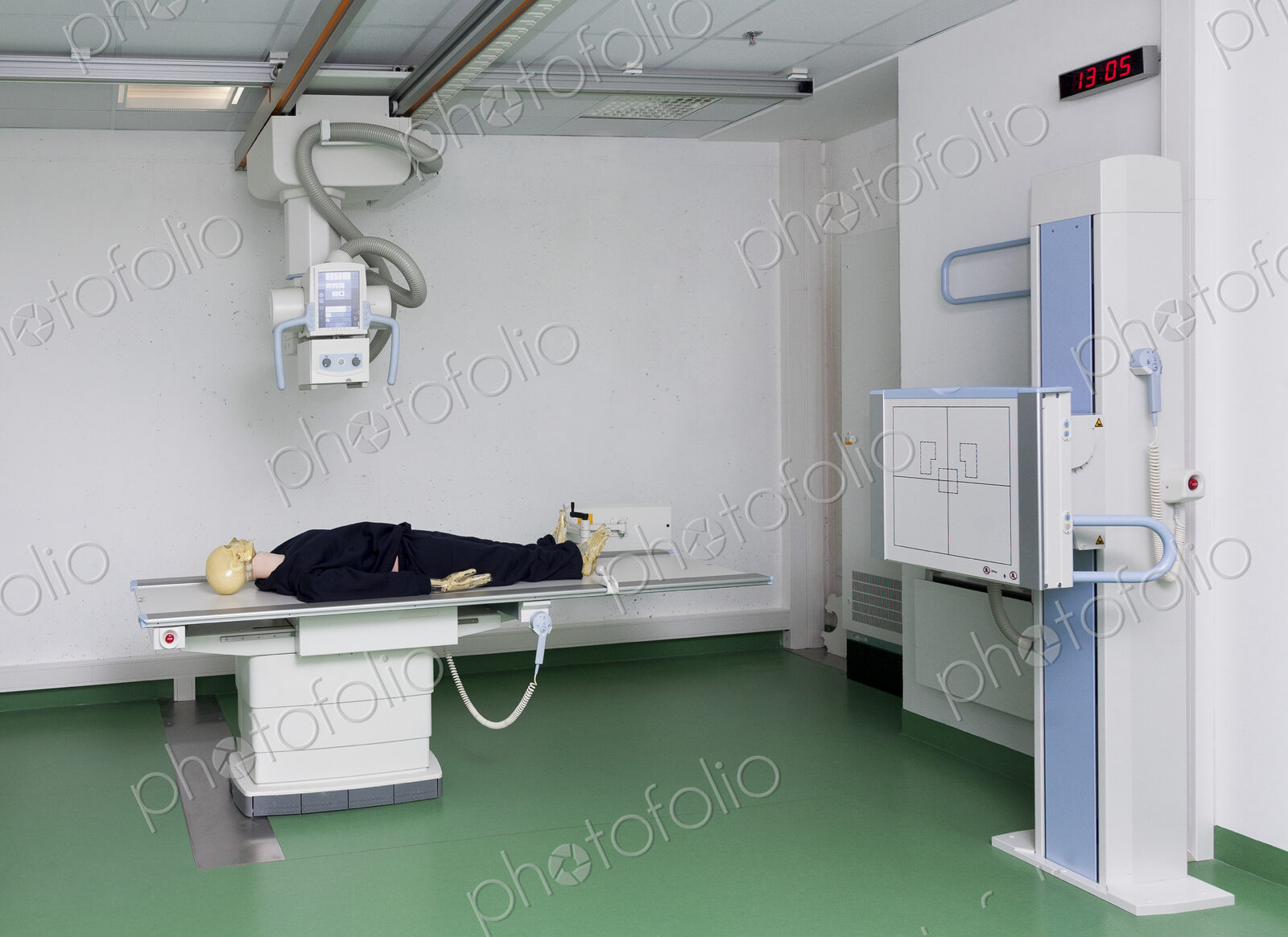 Mannequin lying on a table under an x ray machine in a training college