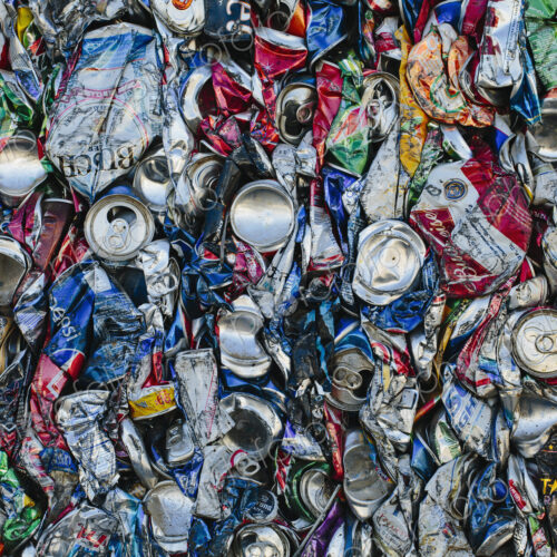 Mass of aluminium cans being processed at a recycling plant.