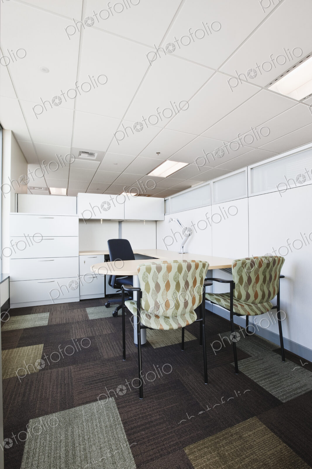 Meeting room in office with chairs at desk.