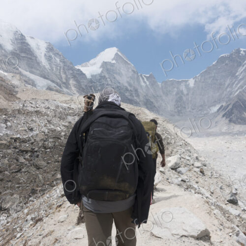 Men hiking toward mountain, Everest, Khumbu region, Nepal Men hiking toward mountain, Everest, Khumbu region, Nepal