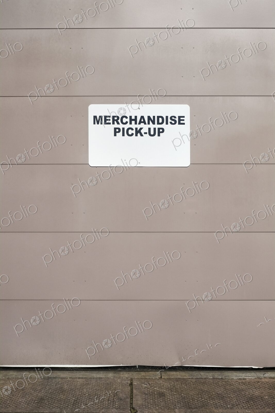 Merchandise Pick-up sign on metal loading dock door, Washington, USA