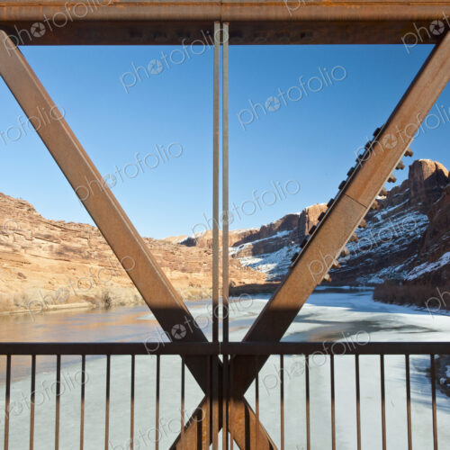 Metal Bridge Beams Against a Rocky Background Metal Bridge Beams Against a Rocky Background