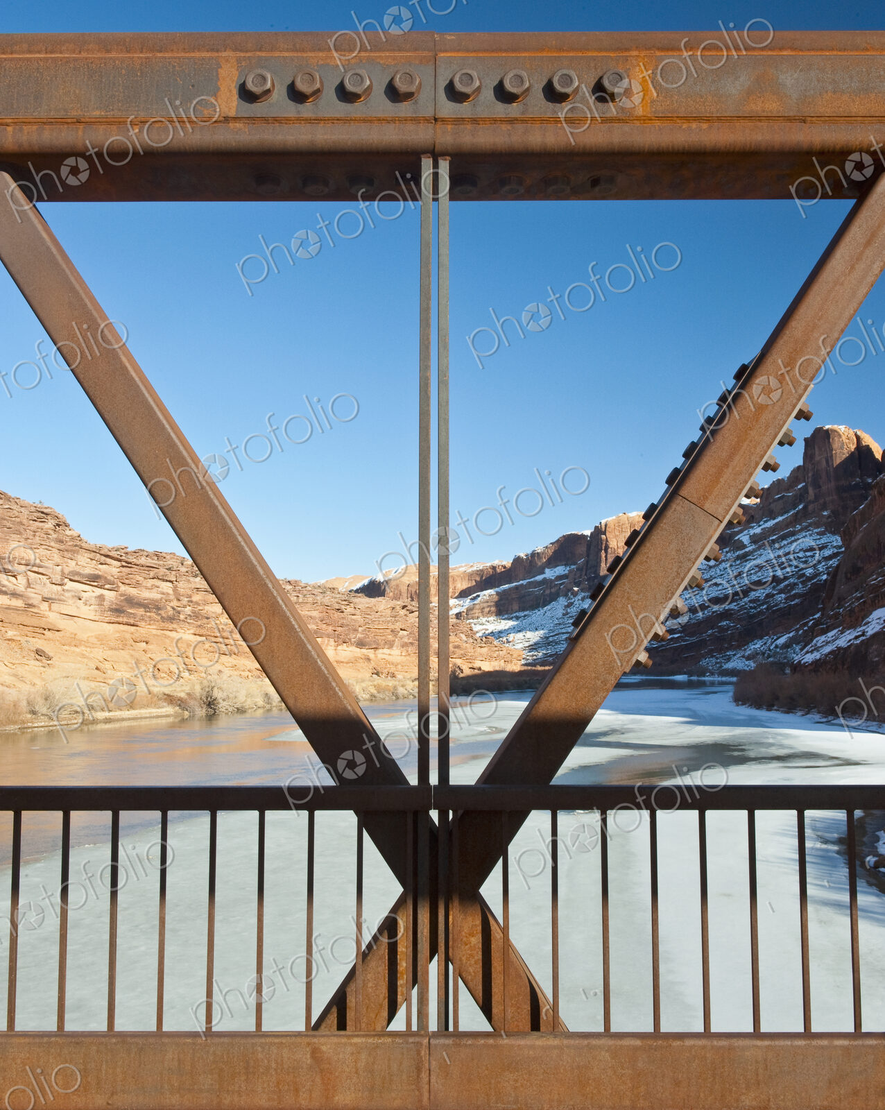 Metal Bridge Beams Against a Rocky Background