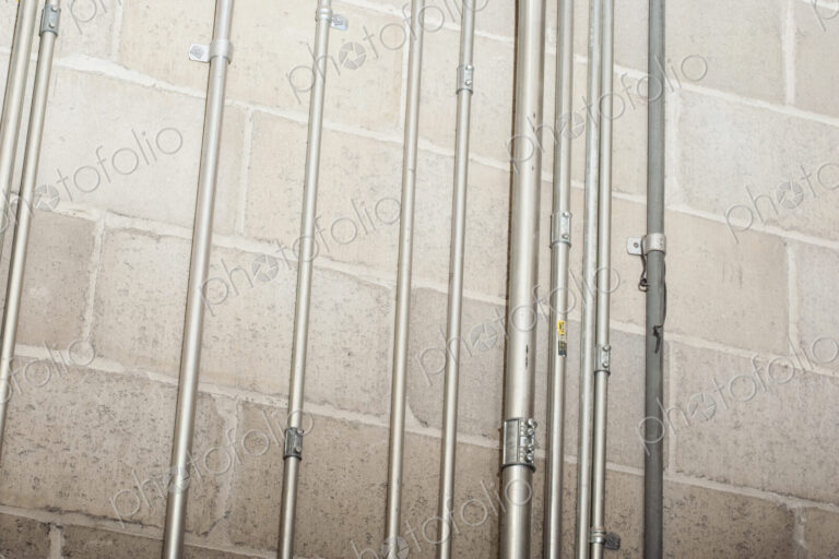 Metal casing for wires on concrete wall.