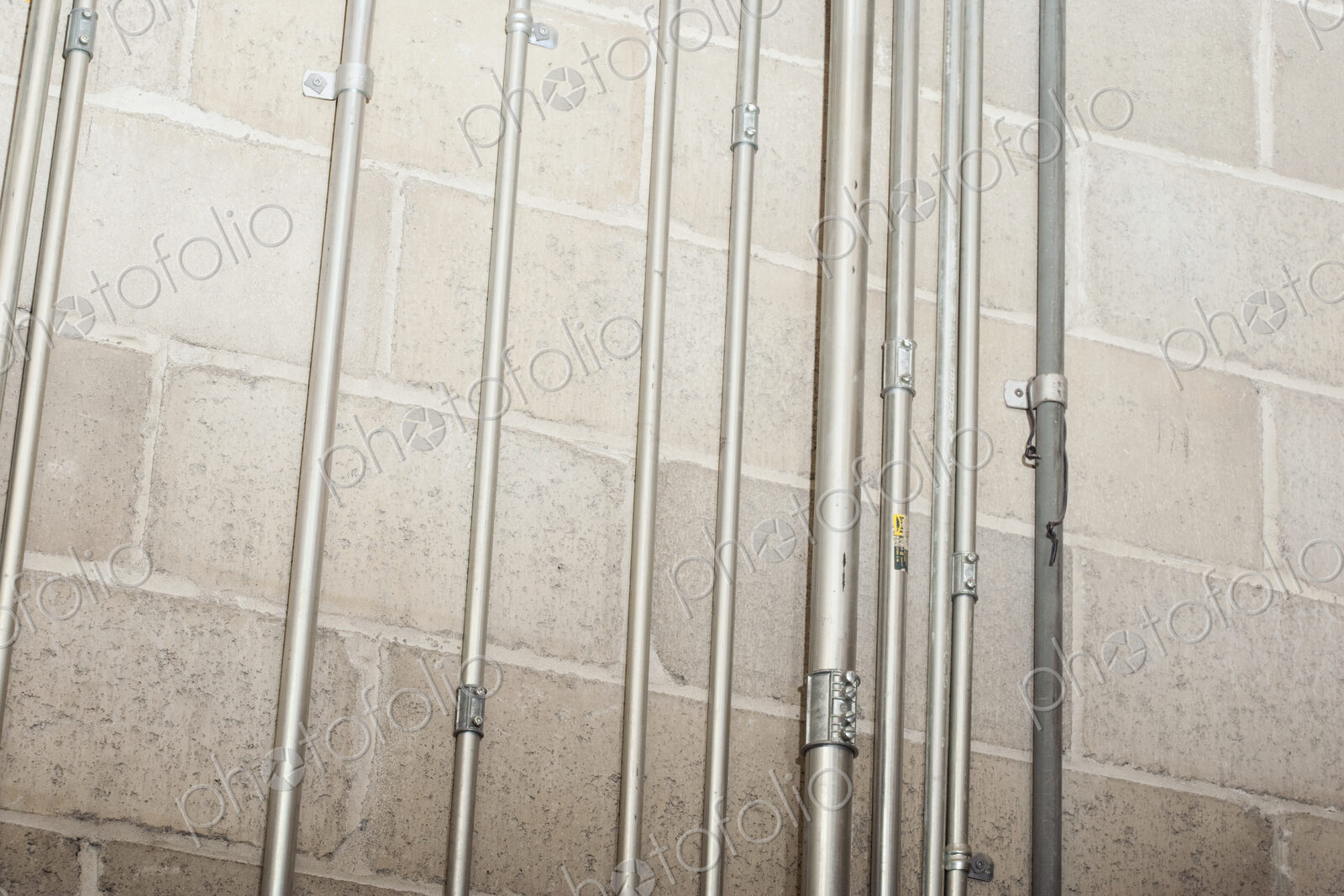 Metal casing for wires on concrete wall.