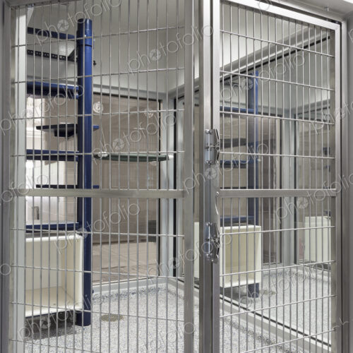 Metal doors of empty cage in animal shelter Metal doors of empty cage in animal shelter