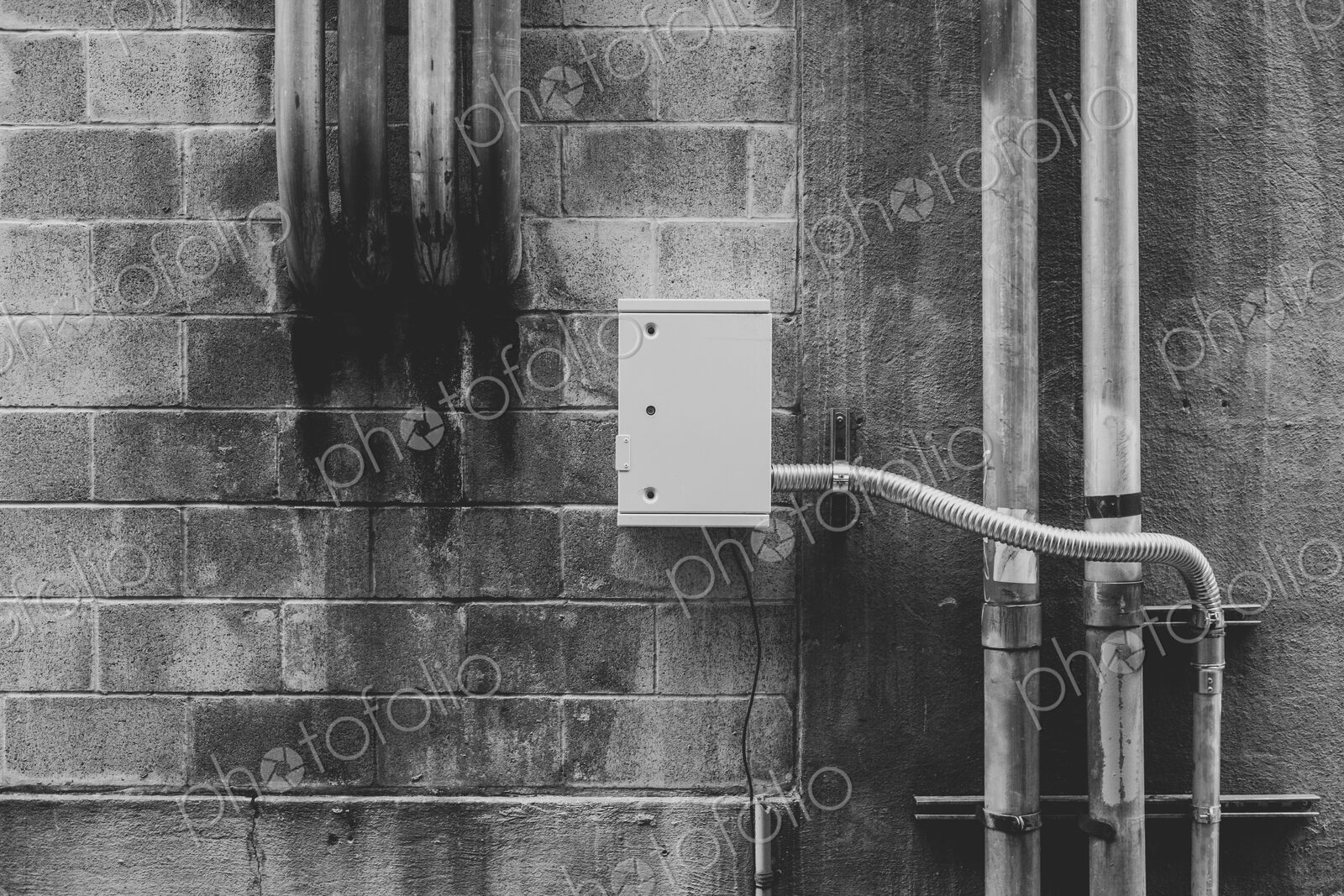 Metal electrical piping on building wall