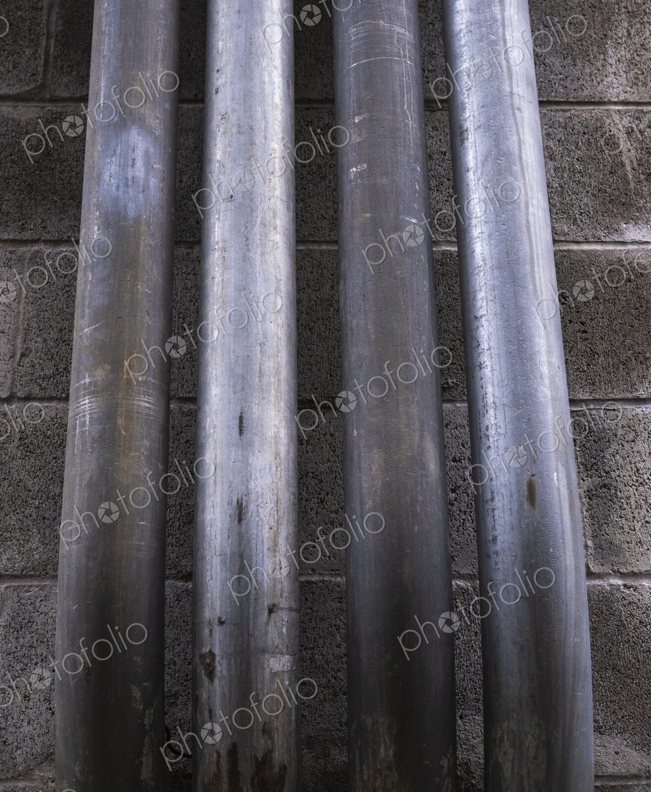 Metal piping against building wall