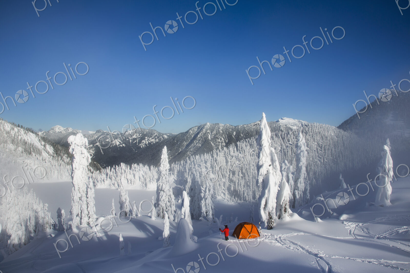 Michael Hanson walks through deep powder to his campsite in the snow covered Cascade…