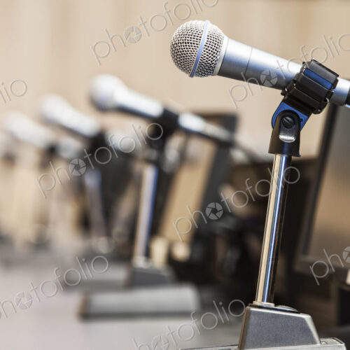 Microphones at a political meeing in city hall. Microphones at a political meeing in city hall.