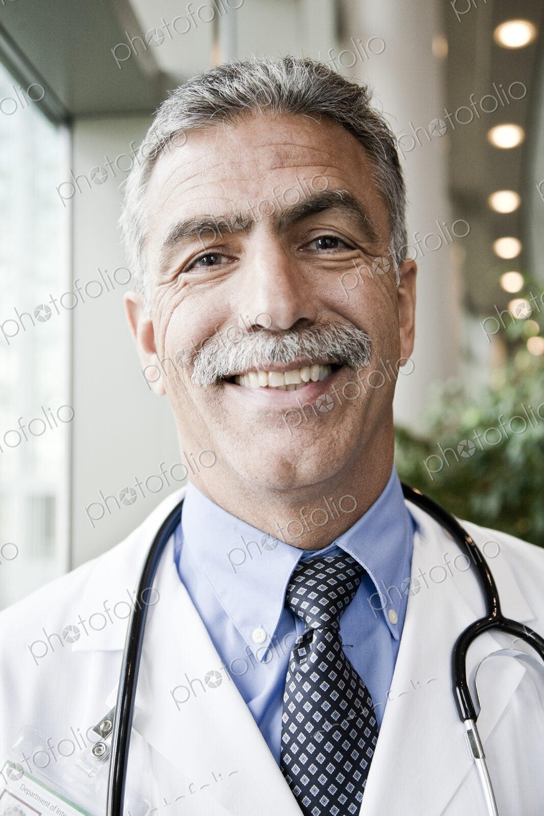 Middle Eastern man doctor in lab coat with stethoscope.