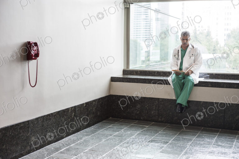 Middle Eastern man doctor texting on a cell phone.