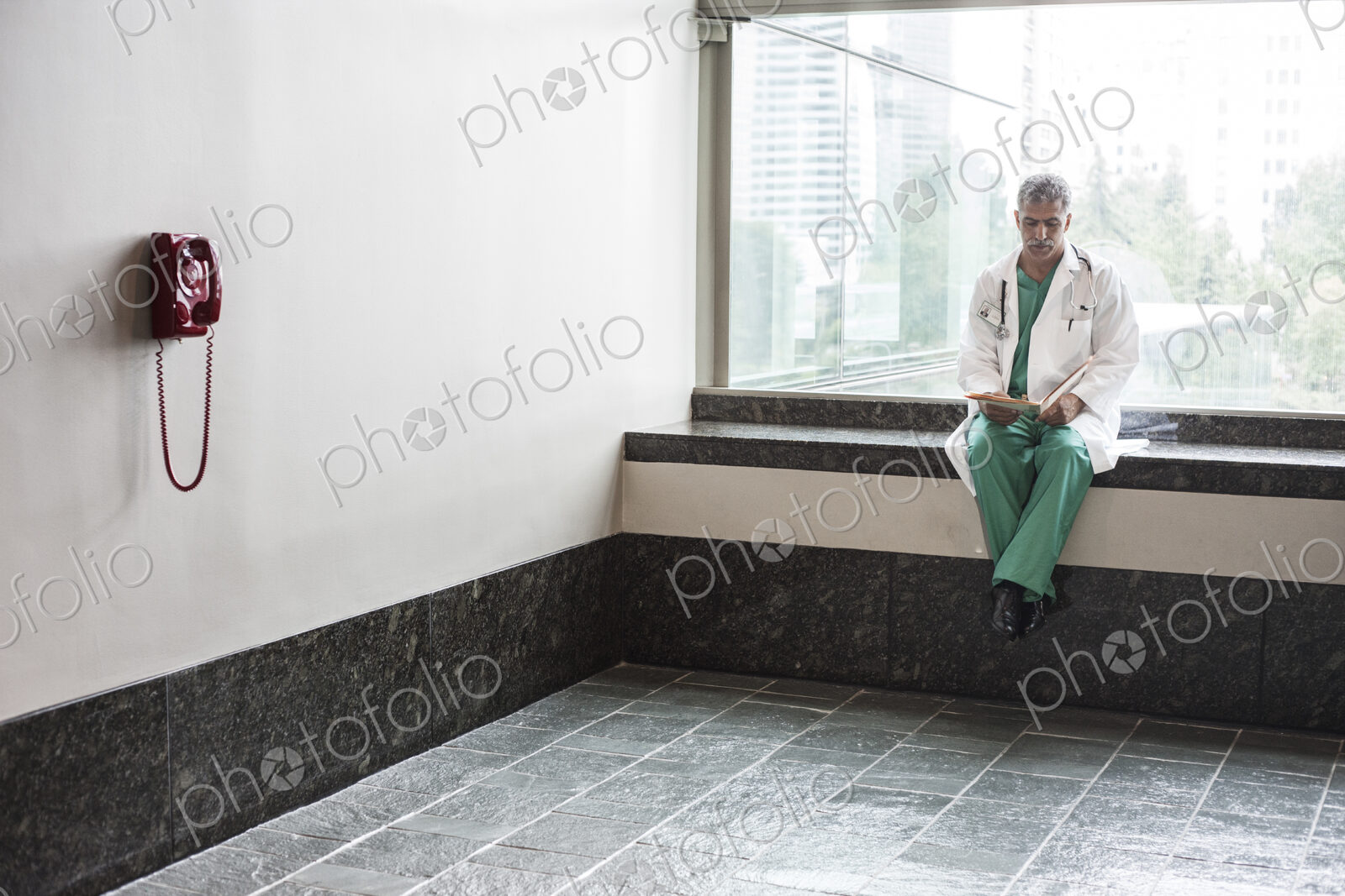 Middle Eastern man doctor texting on a cell phone.