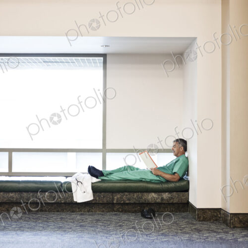 Middle Eastern man doctor wearing scrubs and taking a break. Middle Eastern man doctor wearing scrubs and taking a break.