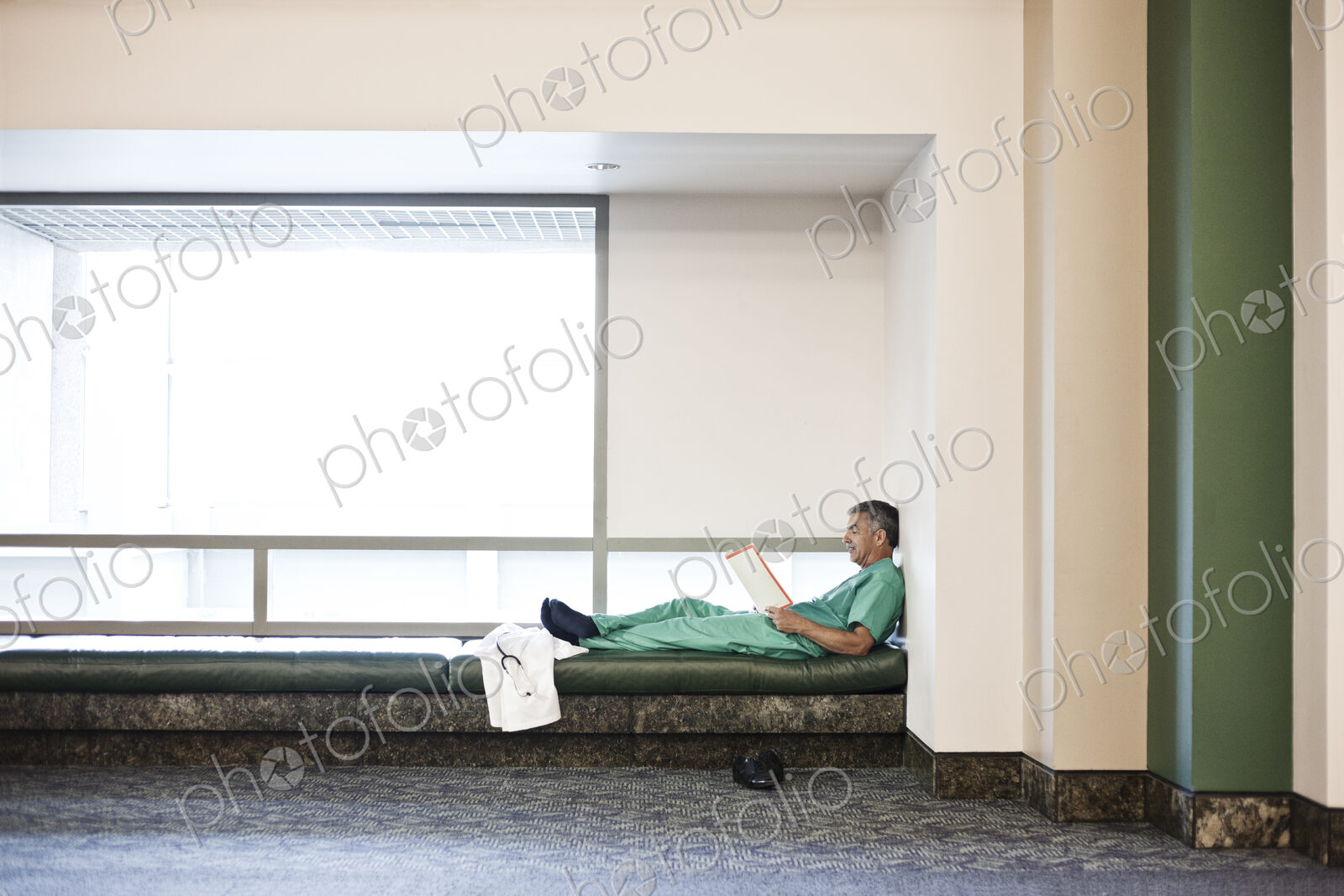 Middle Eastern man doctor wearing scrubs and taking a break.