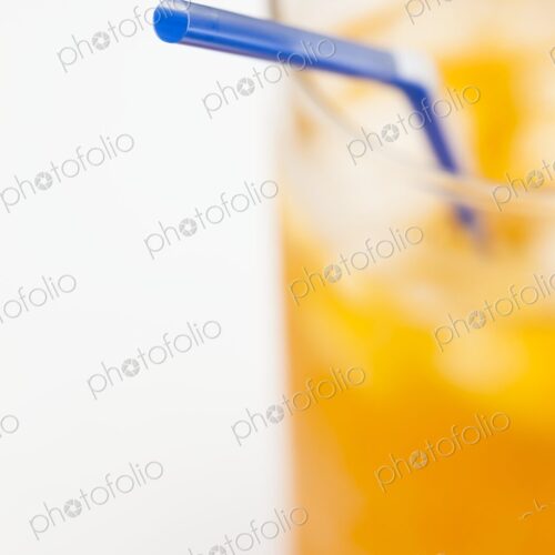 Minimalist close-up of a blue straw in a cold orange beverage with ice. Bright,… Minimalist close-up of a blue straw in a cold orange beverage with ice. Bright,…