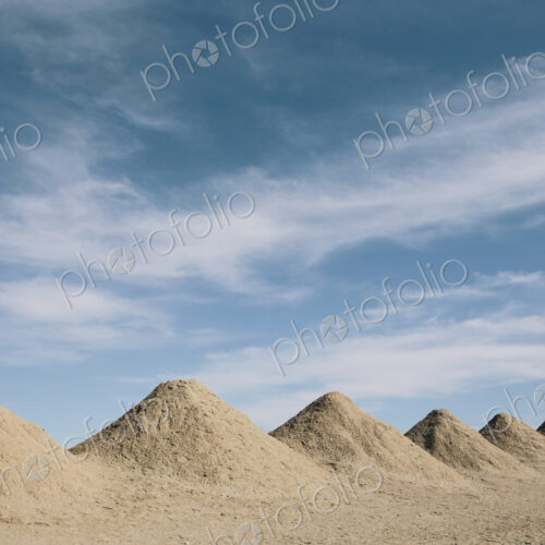 Mining tailings creating row of dirt piles in a desert, mine extraction. Mining tailings creating row of dirt piles in a desert, mine extraction.