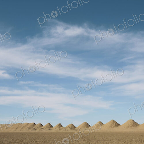Mining tailings creating row of dirt piles in desert. Mining tailings creating row of dirt piles in desert.