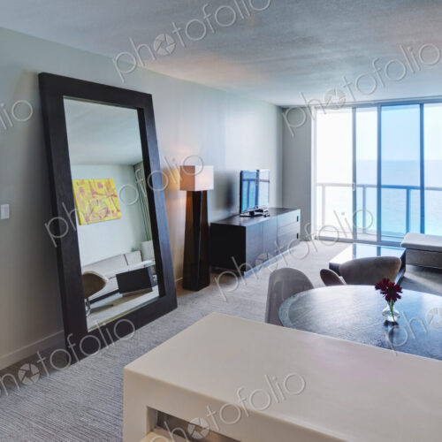 Mirror and lounge area in hotel room Mirror and lounge area in hotel room