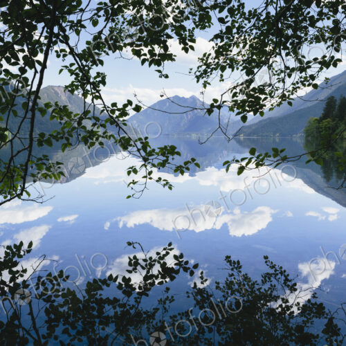 Mirror reflections, the sky and clouds reflected in the surface of hte water of Lake… Mirror reflections, the sky and clouds reflected in the surface of hte water of Lake…