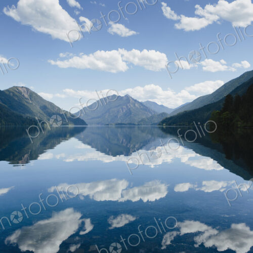 Mirror reflections, the sky and clouds reflected in the surface of hte water of Lake… Mirror reflections, the sky and clouds reflected in the surface of hte water of Lake…