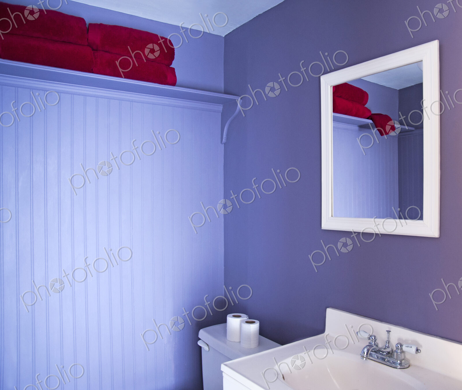 Mirror, sink and toilet in modern bathroom