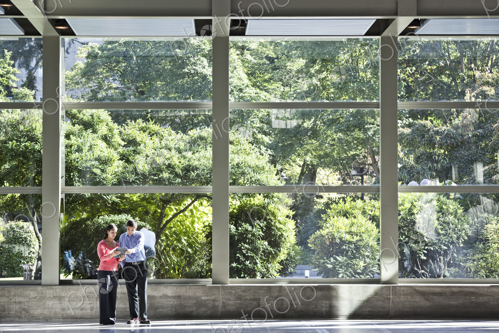 Mixed race caucasian business man and woman in a business center lobby