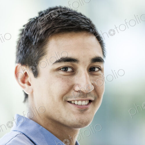 Mixed race caucasian man in a business center lobby.