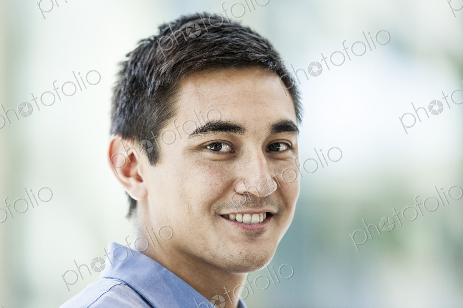 Mixed race caucasian man in a business center lobby.