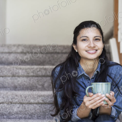 Mixed race caucasian woman with a cup of coffee at home. Mixed race caucasian woman with a cup of coffee at home.
