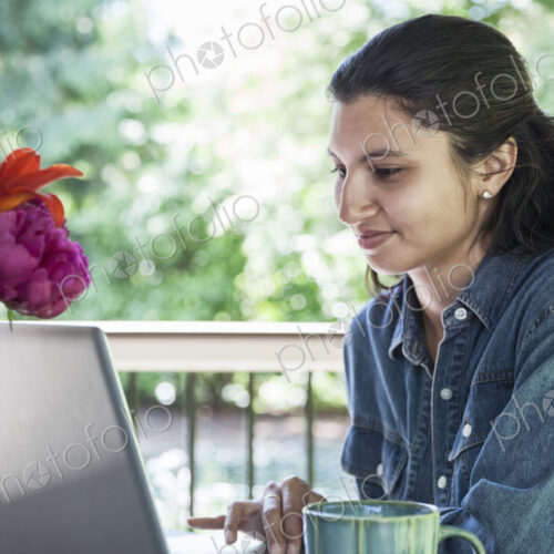 Mixed race caucasian woman working on a laptop at home. Mixed race caucasian woman working on a laptop at home.
