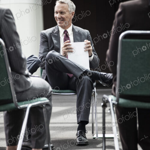 Mixed race group of business people in an informal team building meeting.