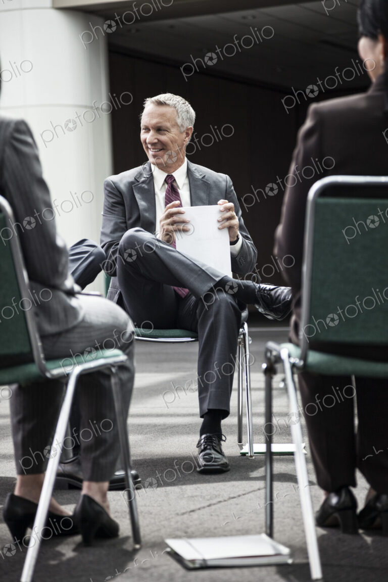 Mixed race group of business people in an informal team building meeting.