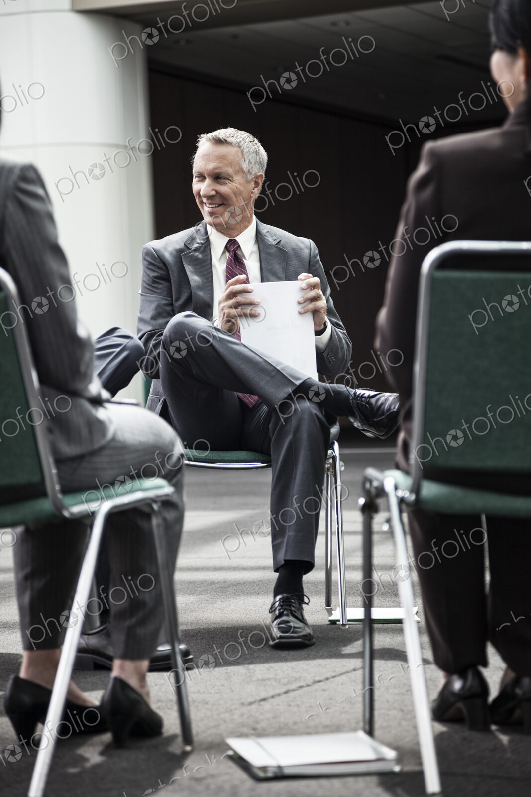 Mixed race group of business people in an informal team building meeting.
