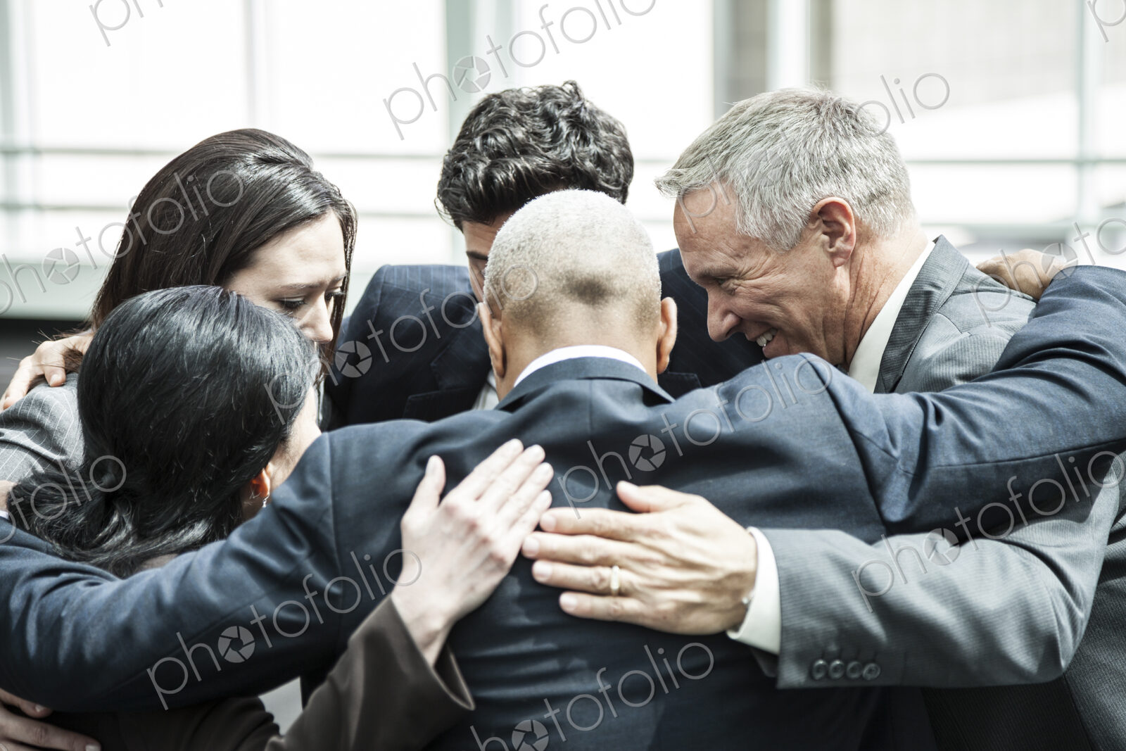 Mixed race group of business people in an informal team building meeting.