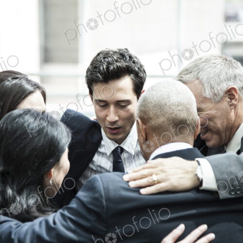 Mixed race group of business people in an informal team building meeting. Mixed race group of business people in an informal team building meeting.