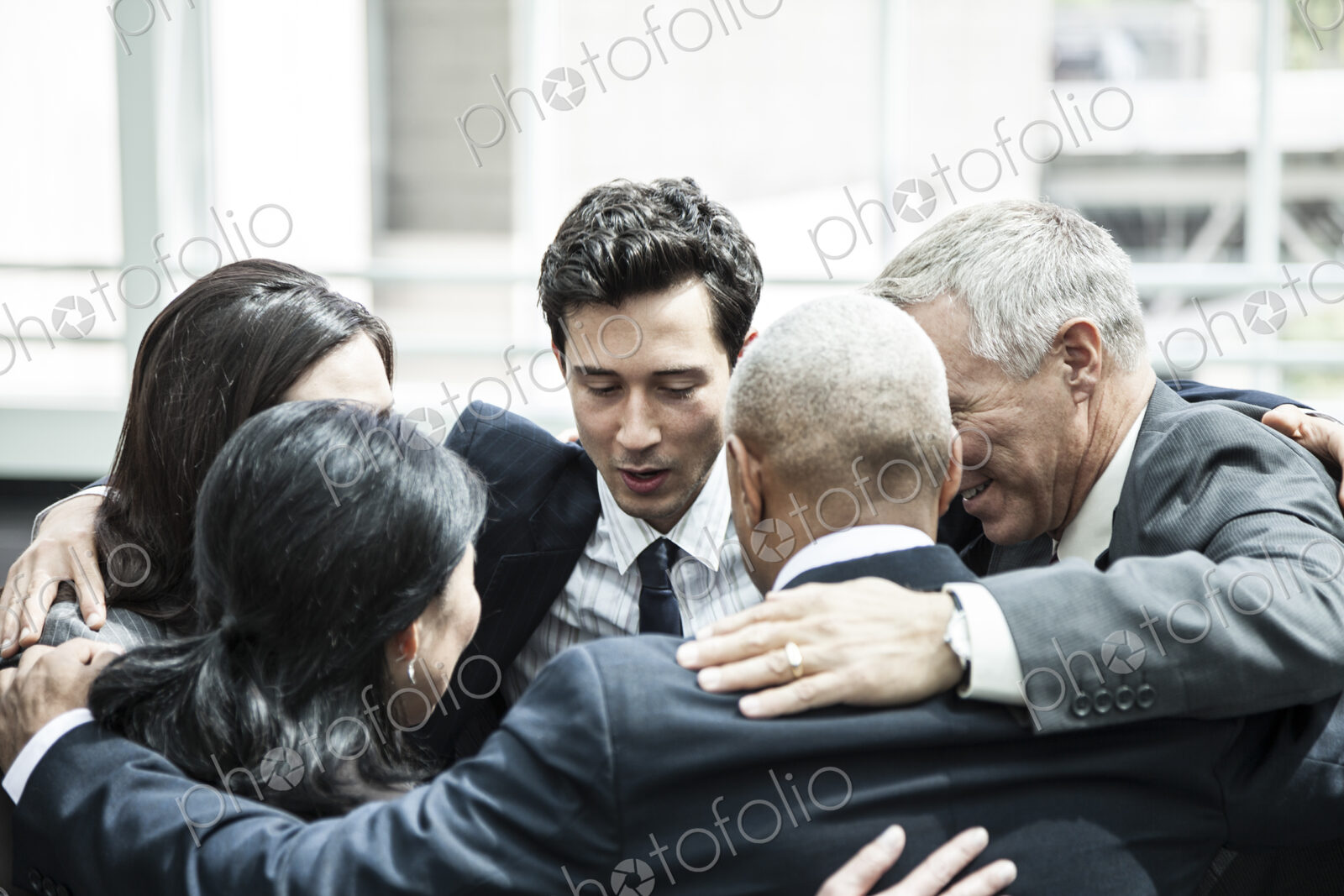 Mixed race group of business people in an informal team building meeting.