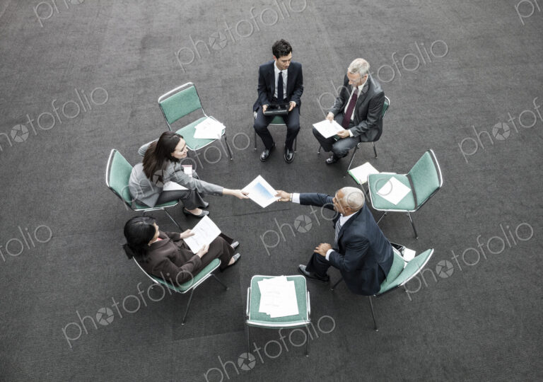 Mixed race group of business people in an informal team building meeting.